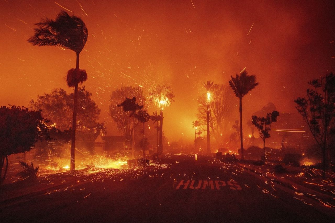 The Palisades Fire ravages a neighborhood amid high winds in the Pacific Palisades neighborhood of Los Angeles, 7 January 2025. 