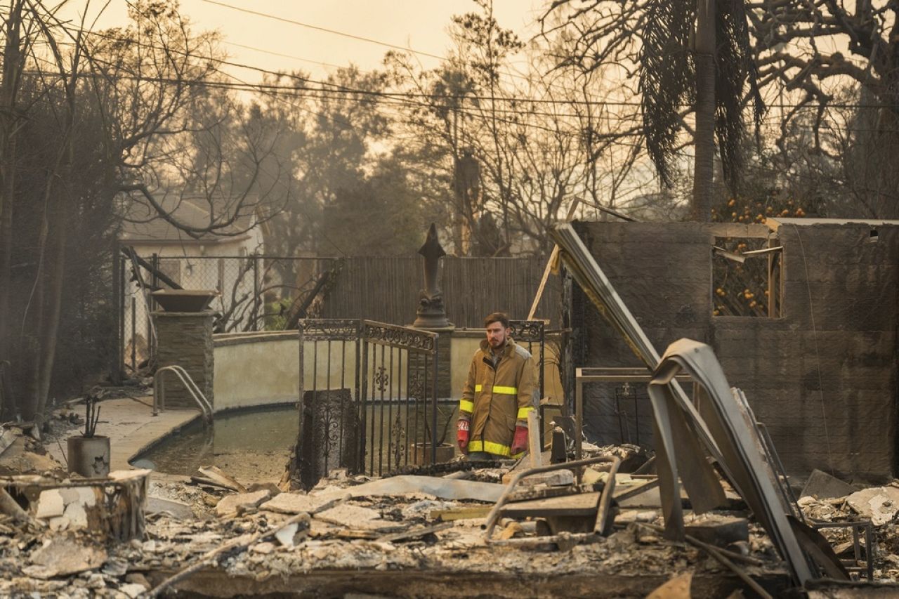 Robert Lara looks through his home that was destroyed after the Eaton Fire burns in Altadena, Calif., Jan. 9, 2025. 