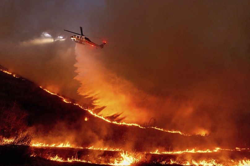 Water is dropped by helicopter on the Kenneth Fire in the West Hills section of Los Angeles, Thursday, Jan. 9, 2025.