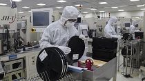 File picture of Workers inspect items at a chip maker in Binzhou city in east China's Shandong province the US has tightened up on exports