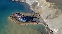 Efforts to contain oil spill from grounded tanker continue as technical barrier completed