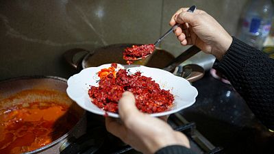 Chahida Boufaied, owner of Dar Chahida Lel Oula, prepares the Harissa in her house in Nabeul, Tunisia, Tuesday, 7 January 2025. 