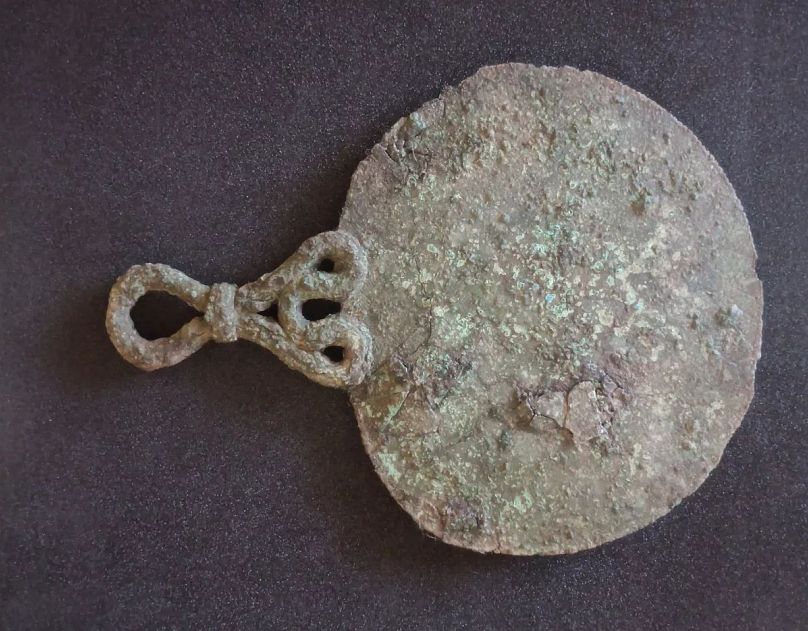 The bronze mirror found in a 2,000-year-old Iron Age burial on Bryher, the Isles of Scilly, just off the coast of Cornwall, England.