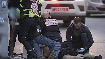 The body of a man who attacked pedestrians with a knife lies covered on the street after he was shot in Tel Aviv, Israel, Saturday Jan. 18, 2025.(AP Photo/Oded Balilty)