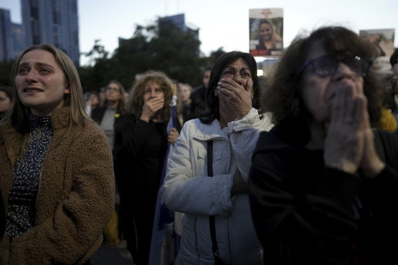 Relatives and friends of people killed and abducted by Hamas and taken into Gaza, react as they gather in Tel Aviv, Israel on Sunday, Jan. 19, 2025. (AP Photo/Oded Balilty)