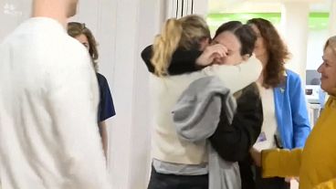 Released hostage Doron Steinbrecher hugging family