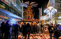 People attend an AfD election campaign in near the Christmas Market in Magdeburg, Germany, Monday, Dec. 23, 2024.