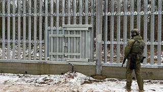 A Polish border guard looks east into Belarus at the crossing point Połowce-Pieszczatka in Polowce, Poland, Thursday, 16 January 2025.