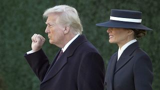 President-elect Donald Trump gestures as he walks with his wife Melania after a church service across from the White House in Washington, 20 January 2025