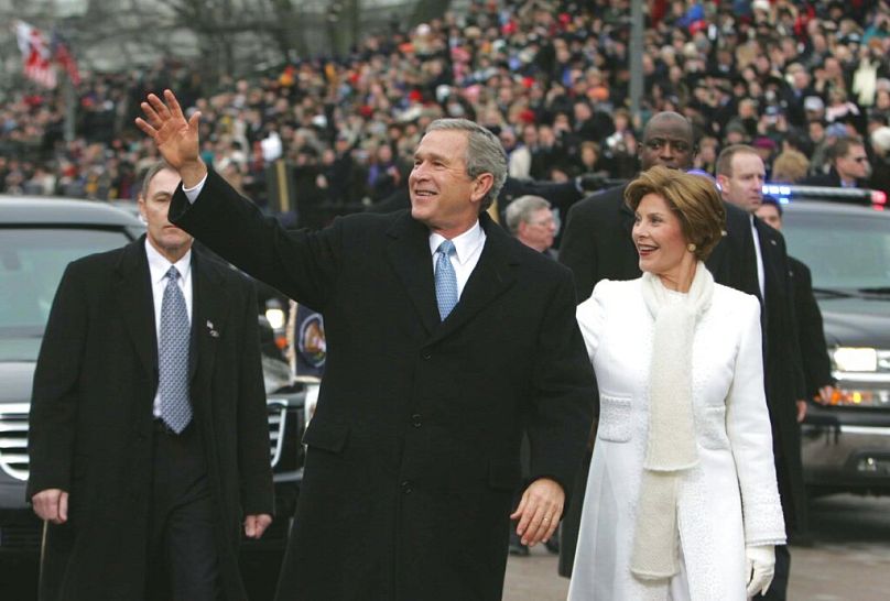 Bush and first lady Laura Bush walk during the inauguration parade infront of the White House. Thursday, Jan. 20, 2005 in Washington