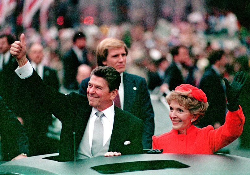 FILE- This Jan. 20, 1981 file photo, shows Ronald Reagan as he gives a thumbs up to the crowd during the inaugural parade in Washington