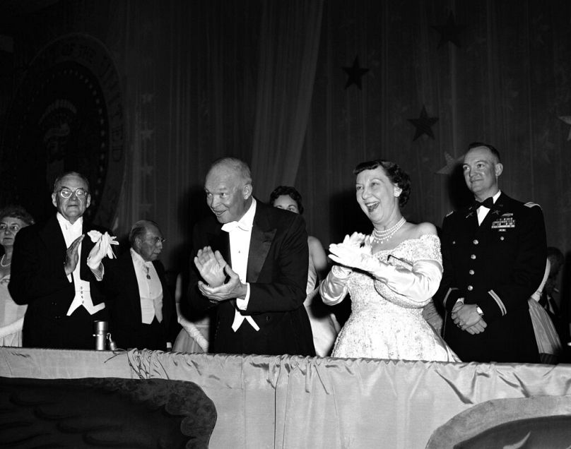 President Dwight Eisenhower and Mrs. Mamie Eisenhower applaud entertainment at the Mayflower Hotel in Washington on Jan. 21, 1957