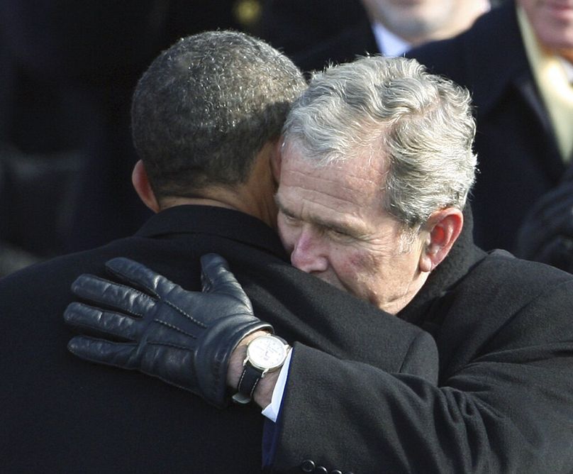 Former President George W. Bush, right, hugs President Barack Obama after Obama was sworn in at the U.S. Capitol in Washington