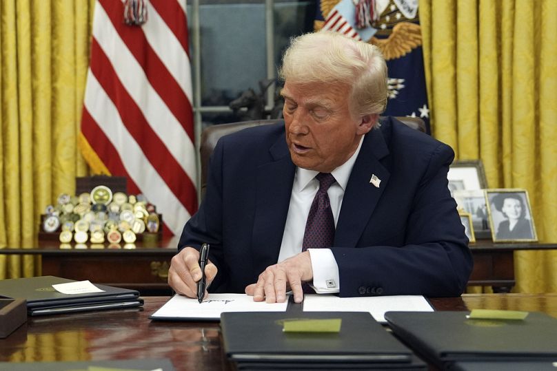 President Donald Trump signs an executive order in the Oval Office of the White House, Monday, 20 January, 2025.