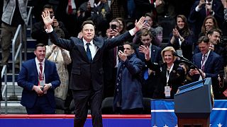 Elon Musk arrives on stage to speak at an indoor Presidential Inauguration parade event in Washington, Monday, Jan. 20, 2025.