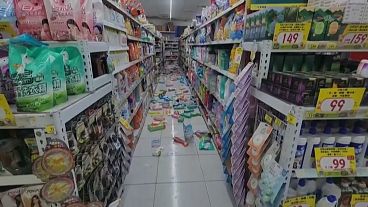 Bottles and cans on floor after falling off shelves at convenience store in Tainan, southern Taiwan, 