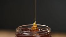 Honey is poured into a glass.