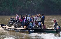 Residents cross a river to Venezuela from Colombia's Tibu, Tuesday, 21 Jan, 2025, following guerrilla attacks that killed dozens and forced thousands to flee their homes.