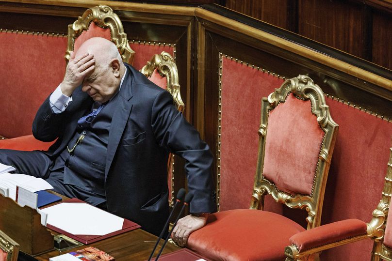 Justice Minister Carlo Nordio puts his hand to his head during the presentation of the report on the justice administration, at the Senate, in Rome, Wednesday, Jan. 22, 2025