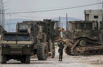 Israeli army vehicles take part in a military operation in the West Bank city of Jenin.