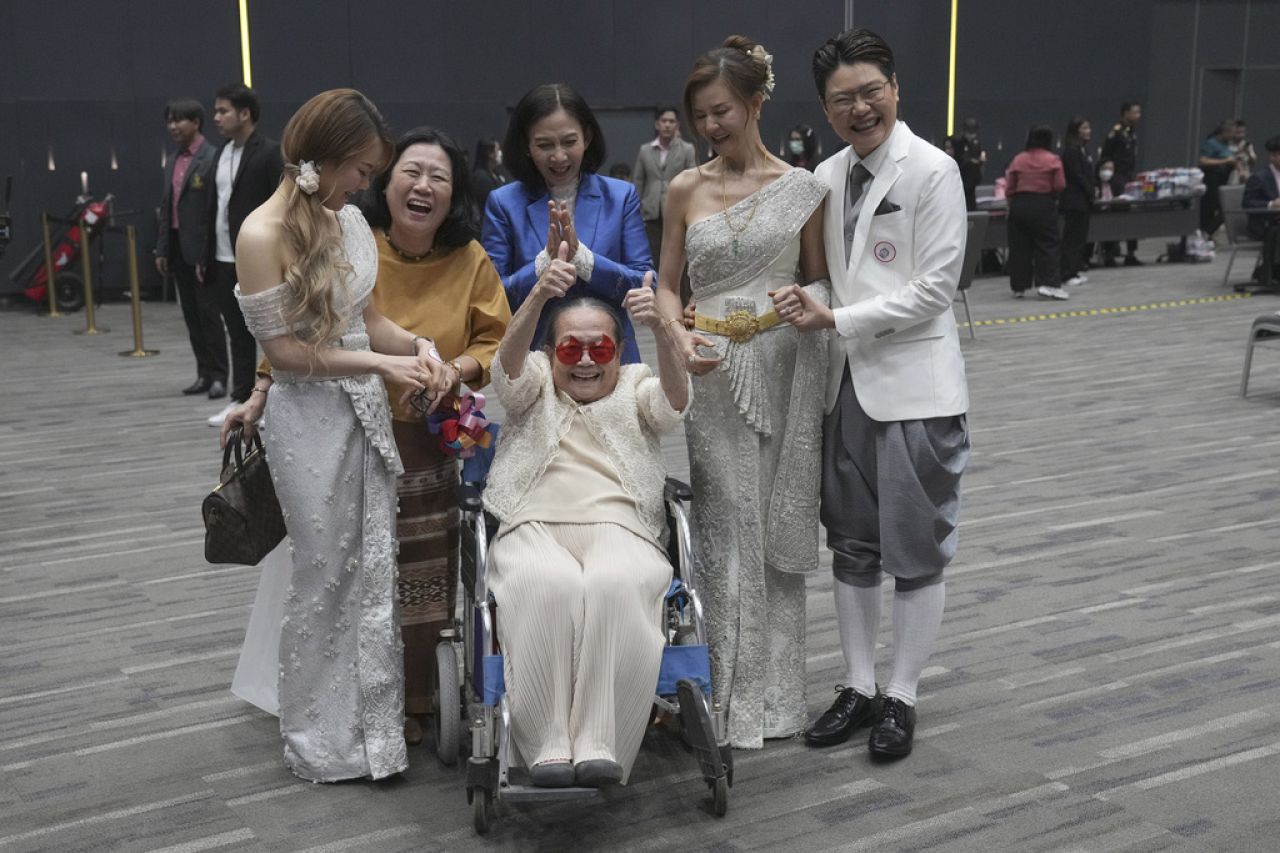 Rungtiwa Thangkanopast (fourth from right) and Phanlavee (right, last name withheld) pose with family members after the Marriage Equality Act took effect in Bangkok, Thailand.