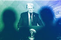 People follow a virtual speech of US President Donald Trump at the Annual Meeting of World Economic Forum in Davos, 23 January 2025