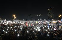 People light up their phones as thousands gather to oppose the policies of populist Prime Minister Robert Fico in Bratislava, 24 January, 2025