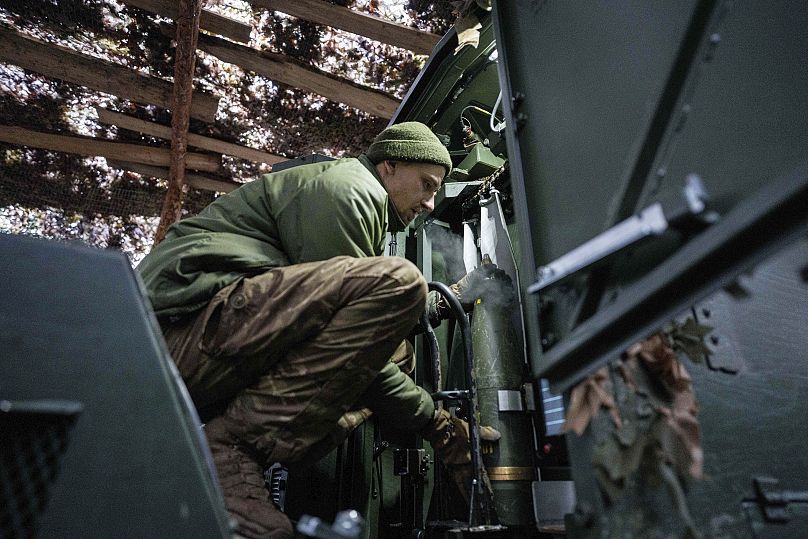 A Ukrainian serviceman loads a 155mm artillery shell into a self-propelled howitzer Dita before firing towards Russian positions in Donetsk, 23 January, 2025