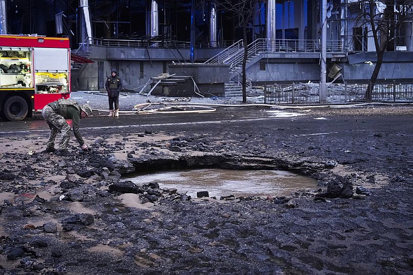 A Ukrainian serviceman collects evidence following a Russian missile attack in Kyiv, 18 January, 2025