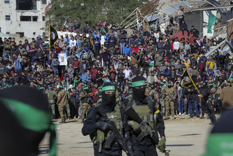 A crowd watches as Hamas and Islamic Jihad fighters deploy in central Gaza City on Saturday, Jan. 25, 2025. (AP Photo/Abed Hajjar)(AP Photo/Abed Hajjar)