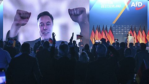 Elon Musk is shown during a live video link at an ADF event in Halle, Germany. 25 Jan 2025.