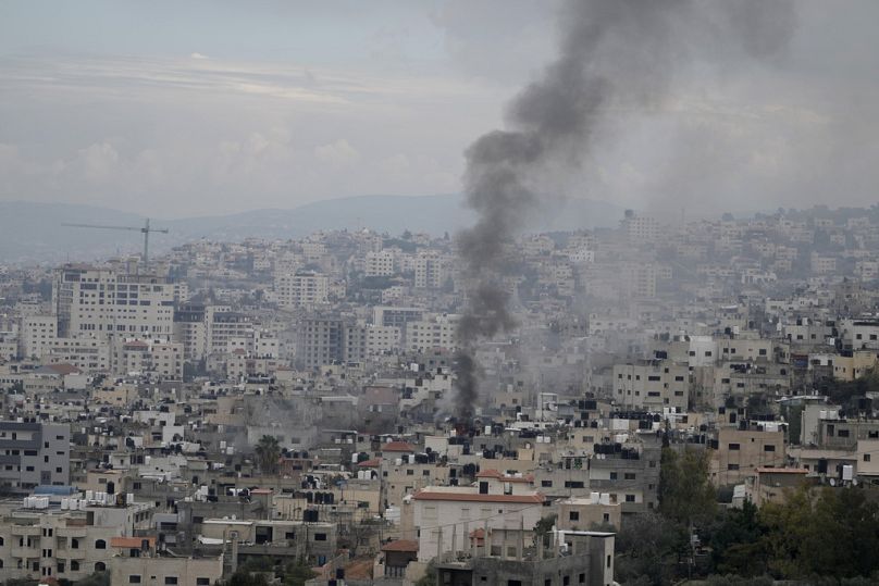 Smoke rises over Jenin refugee camp in the West Bank during an Israeli military operation, Friday, Jan. 24, 2025.