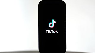 A TikTok logo is shown on a phone, Friday, January 17, 2025.