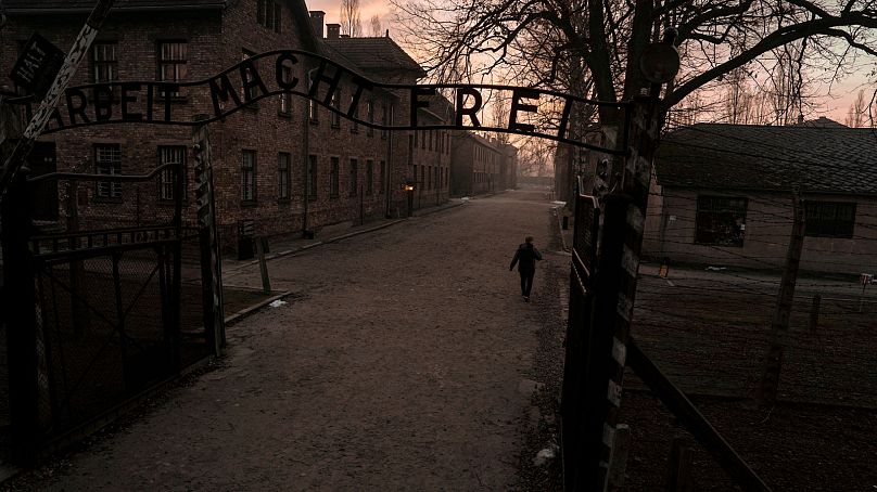 A person walks at the Auschwitz-Birkenau former Nazi German concentration and extermination camp, before a ceremony marking the 80th anniversary of the camp's liberation