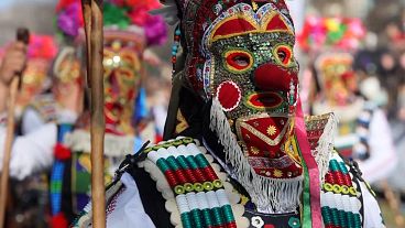 Masked dancers prepare to dance at the masquerade games festival in Pernik, Bulgaria, 25.01.2025