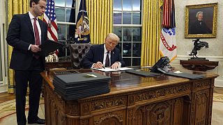 US President Donald Trump signs an executive order withdrawing the US from the WHO in January 2025.