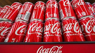 Cans of Coca-Cola are on display at a supermarket in April 2022.