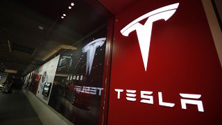 A sign bearing the company logo outside a Tesla store in Cherry Creek Mall in Denver is seen here on Feb. 9, 2019. 