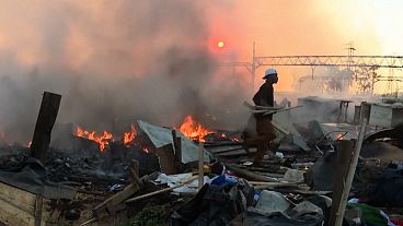 A person recovers what is left of the fire that ravaged the Booysens district of Johannesburg in South Africa, 27.01.2025