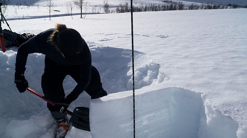 Christopher D’Ambiose checking a snowpack.