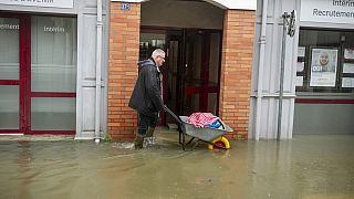 A man uses a wheelbarrow in a street flooded due to storm Ivo, Wednesday, January 29, 2014 in Redon, France, 29.01.2025