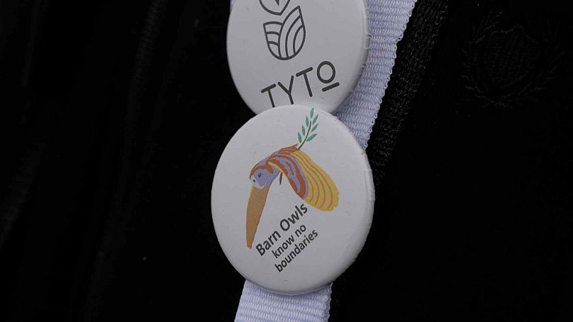 A birdwatcher wears pins for barn owls, and the Greek environmental group TYTO as Karla lake , near the town of Stefanovikeio, Larissa, central Greece, on Jan. 22, 2025.