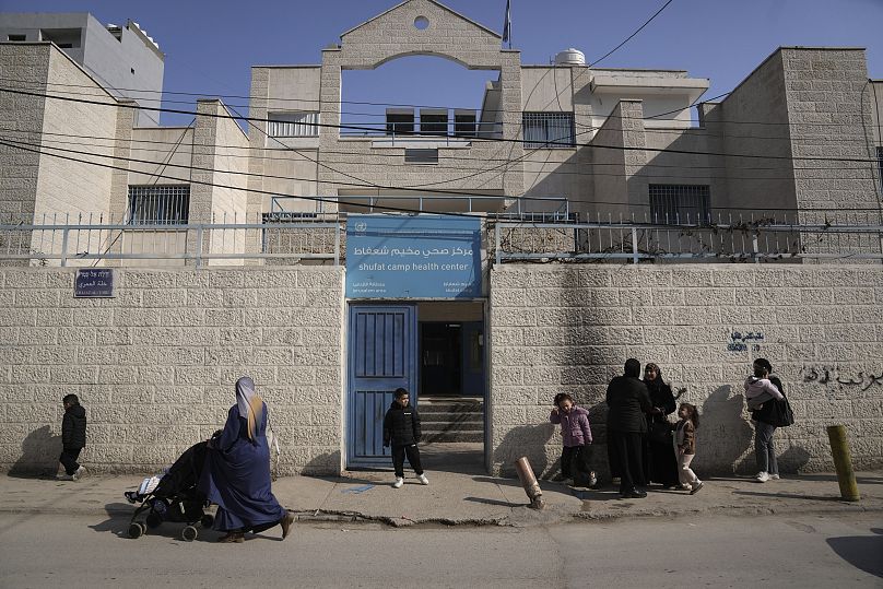 Palestinians gather outside an UNRWA-run health clinic in the Shuafat refugee camp in Jerusalem, 27 January, 2025