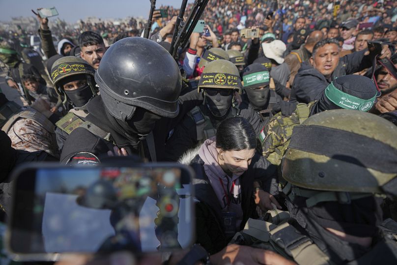 Israeli captive Arbel Yehoud is escorted by Hamas and Islamic Jihad fighters as she is handed over to the Red Cross in Khan Younis, 30 January, 2025