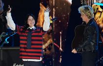 Billie Eilish, left, performs with Billie Joe Armstrong of Green Day during the FireAid benefit concert on 30 January 2025.