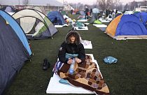A student sits after waking up on a soccer stadium during a protest over the collapse of a concrete canopy that killed 15 people more than two months ago, in Indjija, Serbia.