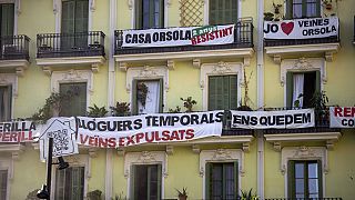 FILE - A block of flats, which is under threat of eviction, in Barcelona, Spain, July 10, 2024.The banner in centre reads: "temporary rental housing: neighbours evicted." 