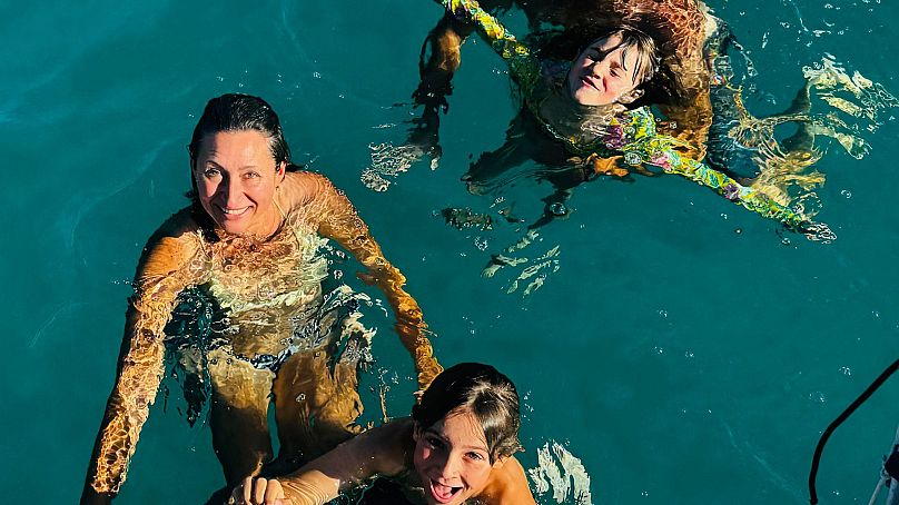 The family take a dip in the ocean - a frequent part of their life at sea