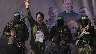 Israeli Ofer Kalderon waves before being handed over to the Red Cross by Hamas fighters in Khan Younis, southern Gaza Strip, Saturday Feb. 1, 2025. Photo/Abdel Kareem)