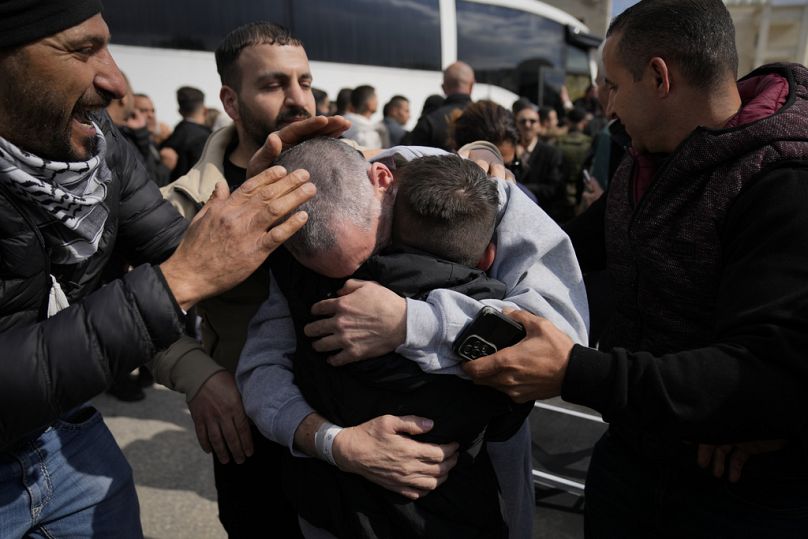 Palestinian prisoners freed by Israel get off Red Cross bus in the West Bank city of Ramallah, Saturday Feb. 1, 2025. (AP Photo/Nasser Nasser)